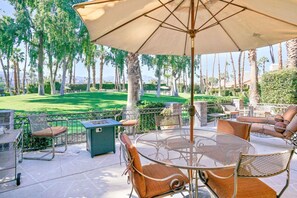 Tables and chairs with an umbrella perfect for an outdoor chat