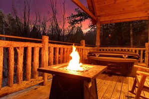 Cozy up by the fire pit on your private deck after a long day exploring!