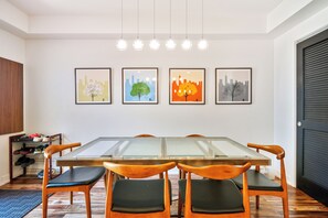 The dining area features a stylish table with seating for 6.