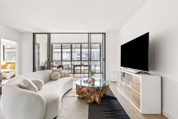 Relax in this stylish living room with a plush sand-textured sofa and unwind with a good book or a favourite show on the TV.