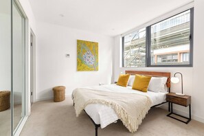 Wake up to natural light and unwind in comfort with a queen bed, built-in robe, and calming wall art. Enjoy the central air conditioning and an ensuite for ultimate comfort.