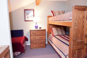 Loft Area with Flat Screen TV has a set of twin bunbeds, and a full bed.