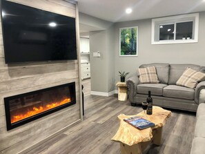 Enjoy relaxing in this living room with a cozy electric fireplace!