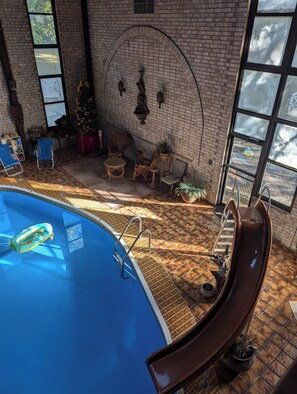 Children's slide and wicker seating in the Pool Room.