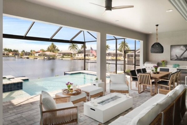Relax and enjoy incredible water views with infinity edge pool & spa (hot tub), gas fireplace, outdoor kitchen (including gas range, beverage fridge & sink)