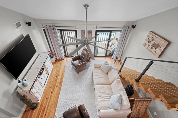 Gather in the spacious living room of our Cotton Bayou condo, complete with a smart TV, comfortable seating, and coastal-inspired decor. It's the perfect place to relax after a day by the pool or exploring the ba