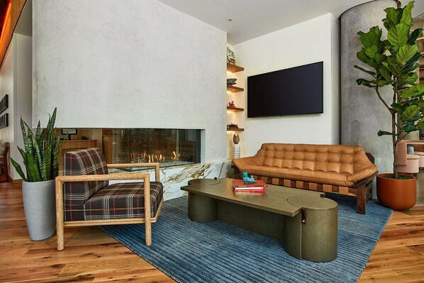 Cozy up by the fireplace in this beautifully designed space, where warm tones, plush seating, and soft lighting create the ultimate ambiance for relaxation and conversation.