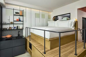 A lofted bed with smart storage underneath, combining sleek design with a cozy sleeping space.