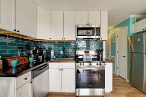Full-sized appliances, full stock of kitchenware, and a stocked 16-spice rack.