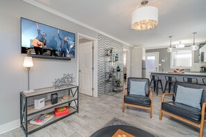 Relax in style with cozy seating, modern decor, and a seamless flow to the kitchen—perfect for comfort and connection!