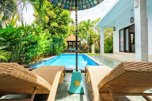 Relax by the outdoor lap pool, cleaned daily & set beside a lush tropical garden