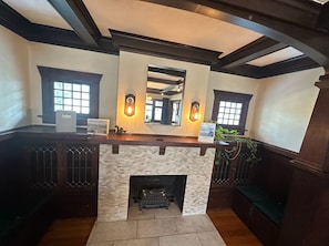 Electric insert fireplace for cozy heating and built-in book nook.