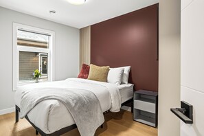 First bedroom with a queen bed and a TV