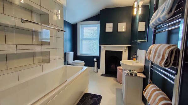 corridor + bath tub + frosted window + decorative fire place.