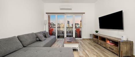 Living Room: Bright space with city views, plush seating, and modern decor for ultimate relaxation!