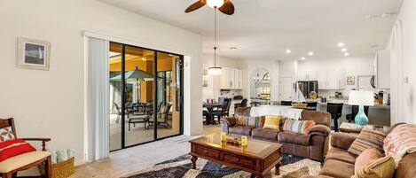 Comfortable family room, open to the kitchen, doors to pool area