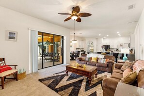 Comfortable family room, open to the kitchen, doors to pool area