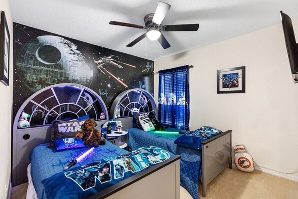 Star Wars twin room with 2 Millennium Falcon Twin beds with lights, Bluetooth speakers charging stations, R2D2 night stand,32” flat screen TV,