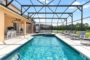 Large private pool with spa, privacy screens, covered lanai with 2 ceiling fans and 2 tables, lake and conservation views