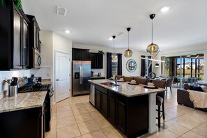 The layout is thoughtfully crafted to create a seamless flow between cooking, dining, and socializing, making it the perfect hub for both everyday living and entertaining.