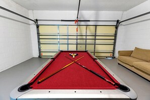 Challenge your crew to a round of pool in this dedicated game room featuring a full-size pool table and comfy seating.