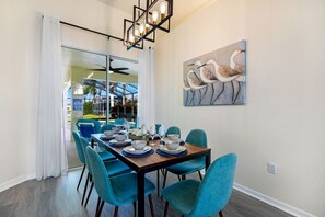 Elegant dining setup for eight, featuring statement lighting and a chic, modern vibe.