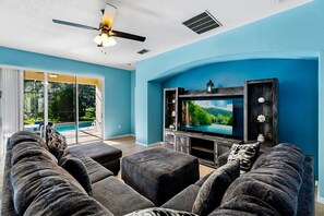 Welcoming open living room with a captivating view of the pool