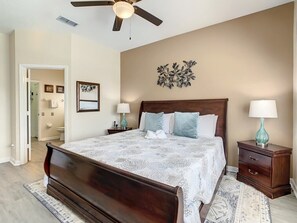 The spacious master bedroom offers rich wooden furnishings, soft lighting, and direct access to a private ensuite. Just minutes from Walt Disney World, this room is a luxurious haven for rest and relaxation.