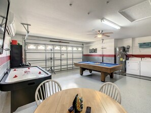 Have fun without leaving the house! This converted garage game room features air hockey, a pool table, and laundry—perfect for vacationing families. Located near Disney in sunny Orlando, Florida, it's a playful and convenient retreat for all.