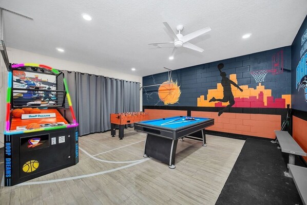 Exciting game room with pool table, Foosball and basketball