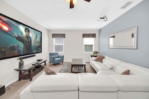 Living room 2 - Comfortable sectional with large flat screen TV.