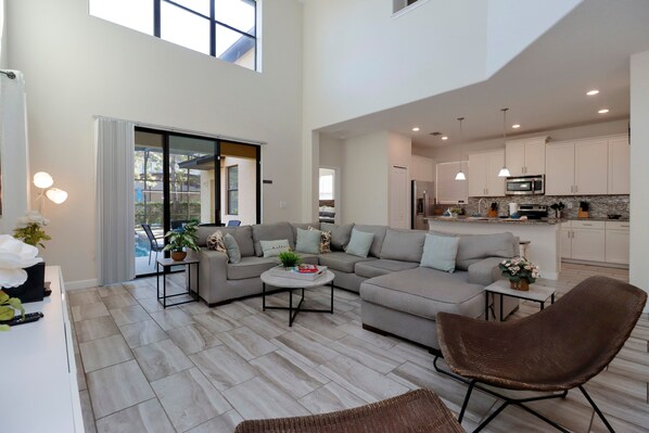 Relax in style with plush seating, soaring ceilings, and a sleek flat-screen TV.