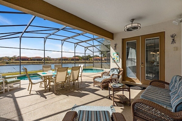 A beautiful covered outdoor seating area situated right by the pool. This space is for relaxation and enjoyment, providing a perfect spot to unwind while staying shaded from the sun.