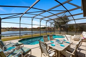 The deck is adorned with a variety of comfortable seating options, including lounge chairs, cushioned sofas, and stylish outdoor dining sets.