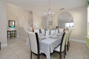 The formal dining area offers seating for eight and is thoughtfully styled for both everyday meals and special gatherings. Located just off the kitchen in Solterra Resort, this space adds a touch of elegance and functionality to your Florida home base near Disney.