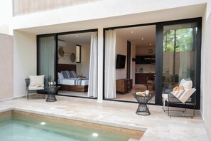 Light-filled corner with plush seating and tropical garden views.