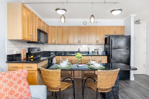 Fully equipped kitchen and a dining area with 4 chairs