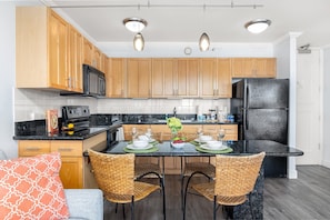 Fully equipped kitchen and a dining area with 4 chairs