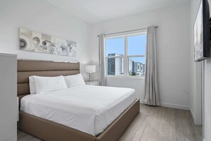 Unwind in this inviting bedroom, featuring a king size bed and soft, neutral tones - Floor to ceiling windows let in plenty of natural light, brightening your stay - Thoughtfully designed for comfort and relaxation after a day of adventure
