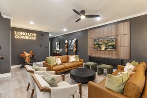 A cozy living room featuring a bold 'LONG LIVE COWBOYS' LED design that shines with rustic charm.