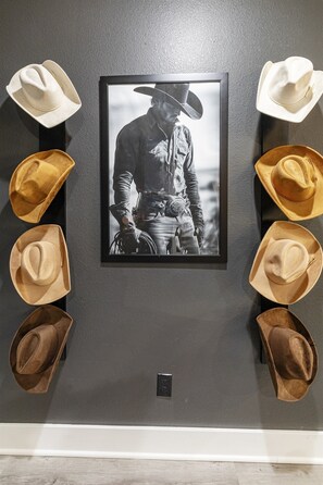 A tribute to the cowboy spirit with iconic hats and a timeless photo centerpiece.