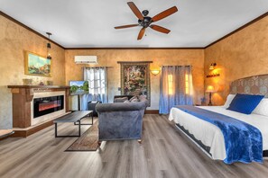 Such a cozy space with a king bed and electric fireplace