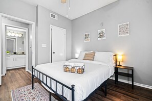 The bedroom offers a luxurious retreat, with a bed that promises restful nights and a room that feels like a private oasis.