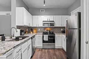 The kitchen invites you to experiment with new recipes, offering a stylish and practical space to cook and create.