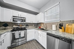 As you open the kitchen, you discover an assortment of coffee pods, and sugar, ensuring you have everything you need for a perfect morning or afternoon pick-me-up.