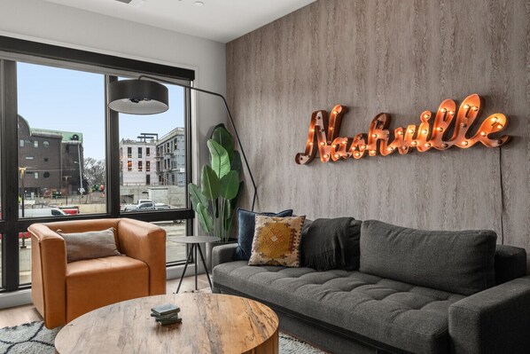 Relax in style in this cozy Nashville living room with vibrant city views