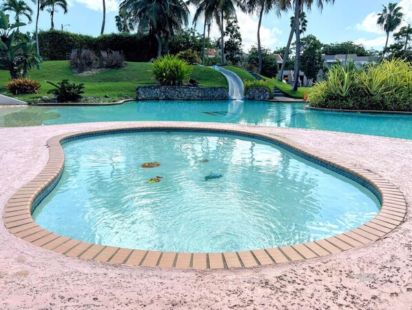 Kids pool, main pool, and water slide from upper pool
