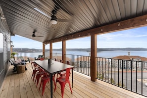 - Dine outdoors at a sleek table with seating for eight under a shaded, fan cooled space
- Enjoy panoramic lake views and breezy meals on this beautiful covered deck
- Ideal for group gatherings, sunset dinners, or relaxed morning coffee