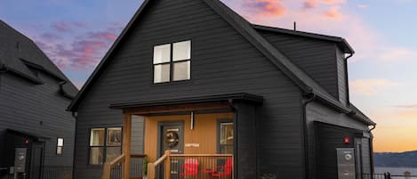 Stylish cabin blends modern design with rustic charm, offering stunning lake views, cozy comforts, and a front porch made for unforgettable sunsets
