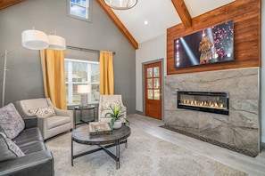 Bright and inviting living room with cozy seating, vaulted ceilings, and stylish décor—perfect for relaxing after a day of exploring!